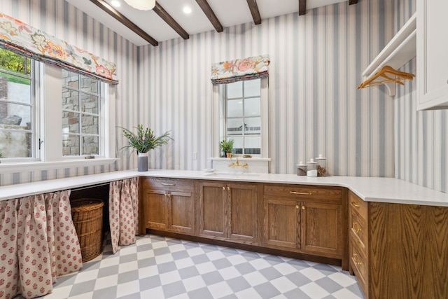 interior space with beamed ceiling and sink