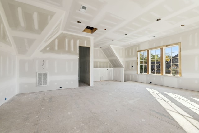 unfurnished living room featuring vaulted ceiling