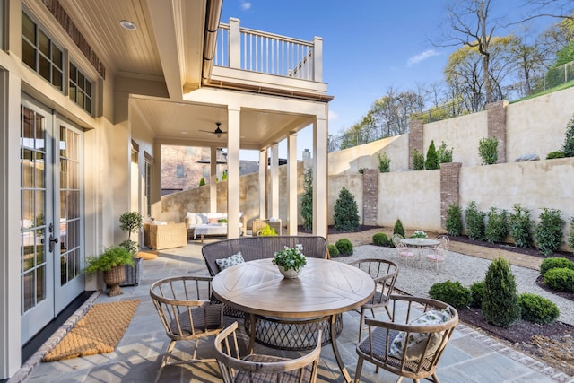 view of patio featuring outdoor lounge area, french doors, a balcony, and ceiling fan