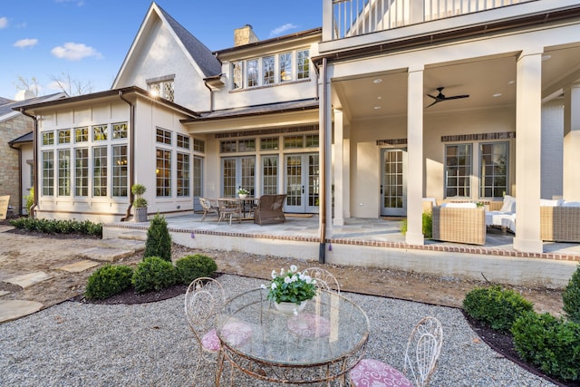 rear view of house featuring french doors, a balcony, an outdoor living space, ceiling fan, and a patio