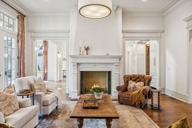 sitting room with dark hardwood / wood-style flooring and crown molding