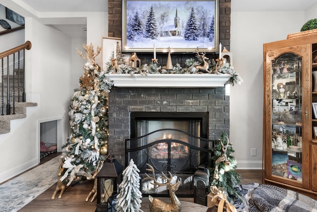 room details featuring a fireplace and wood-type flooring