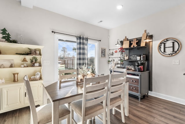 dining space featuring dark wood-type flooring