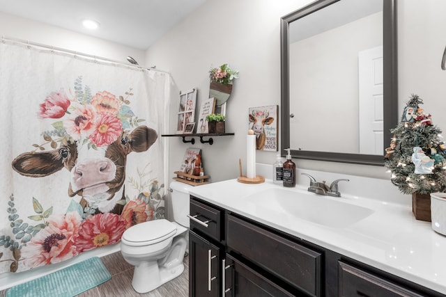 bathroom featuring tile patterned floors, vanity, curtained shower, and toilet