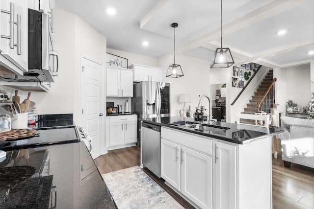 kitchen with stainless steel dishwasher, sink, decorative light fixtures, dark hardwood / wood-style floors, and white cabinetry