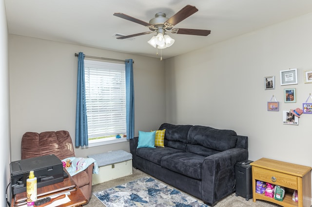 carpeted living room featuring ceiling fan