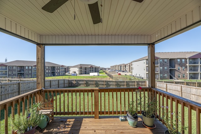 deck with a lawn and ceiling fan