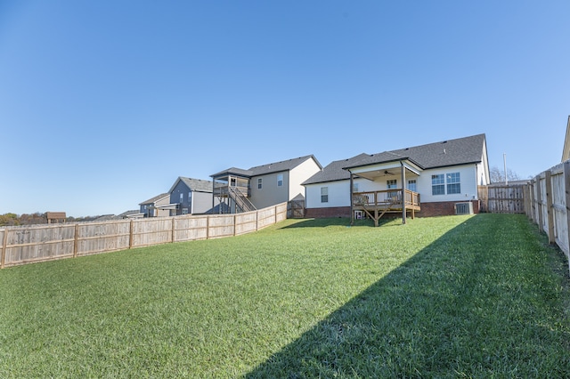 view of yard with ceiling fan, central AC unit, and a deck