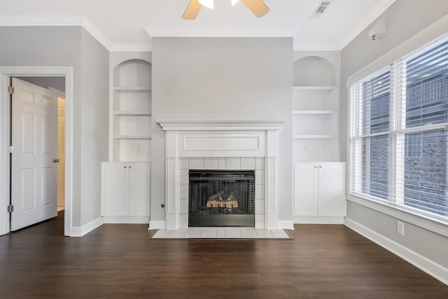 unfurnished living room featuring built in shelves, ceiling fan, and dark hardwood / wood-style flooring