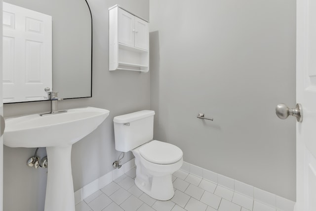 bathroom with tile patterned flooring and toilet