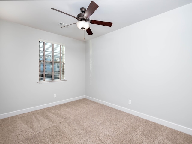 carpeted spare room with ceiling fan