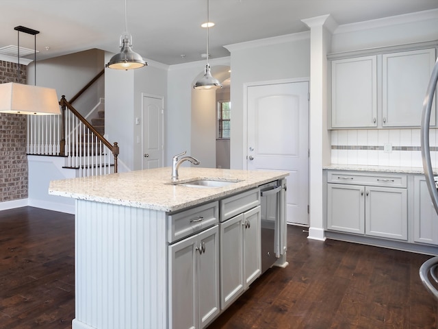 kitchen featuring pendant lighting, a center island with sink, dark hardwood / wood-style floors, and sink