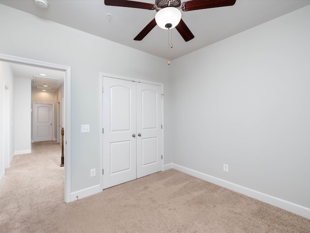 unfurnished bedroom with light carpet, a closet, and ceiling fan