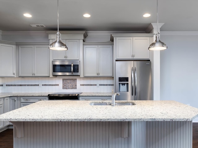 kitchen featuring sink, dark hardwood / wood-style floors, light stone countertops, appliances with stainless steel finishes, and decorative light fixtures