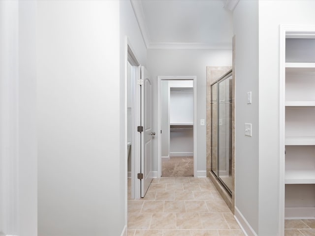 corridor featuring light tile patterned floors and ornamental molding