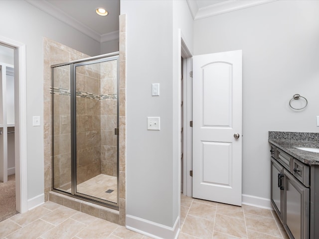 bathroom with crown molding, a shower with door, vanity, and tile patterned flooring