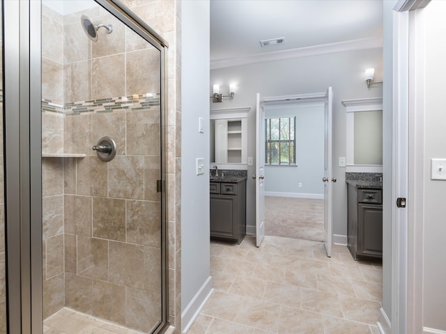 bathroom featuring vanity, a shower with shower door, and ornamental molding