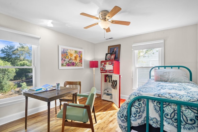 bedroom with hardwood / wood-style floors and ceiling fan