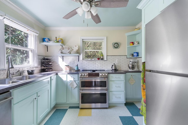 kitchen with sink, crown molding, ceiling fan, tasteful backsplash, and stainless steel appliances