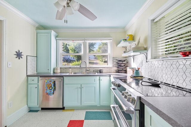 kitchen featuring backsplash, ornamental molding, stainless steel appliances, ceiling fan, and sink