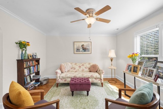 living room featuring wood-type flooring, ceiling fan, and ornamental molding