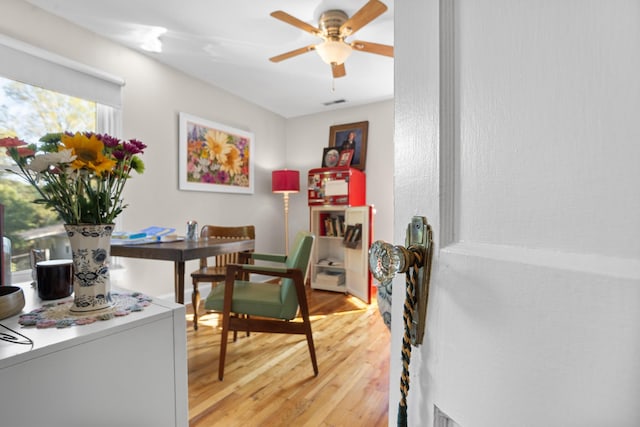 dining space with ceiling fan and wood-type flooring