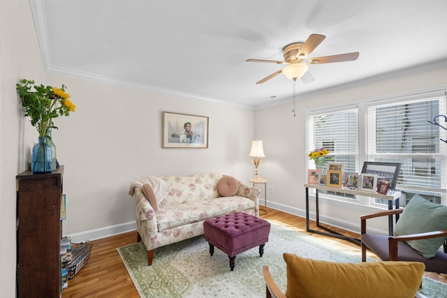 living room featuring ceiling fan, hardwood / wood-style floors, and ornamental molding