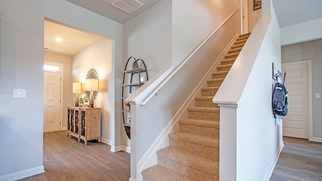 stairs with hardwood / wood-style floors