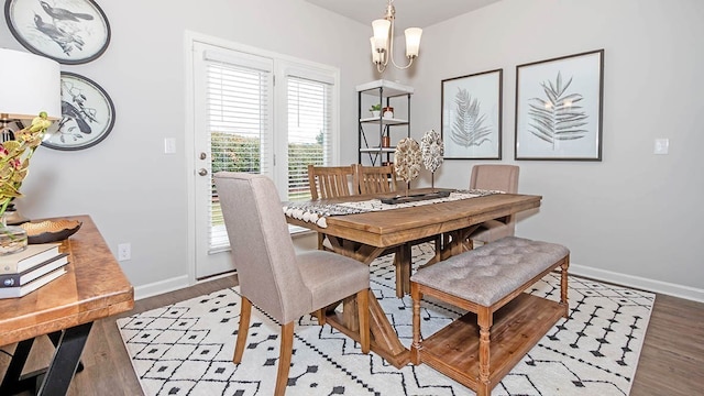 dining area featuring a notable chandelier and light wood-type flooring