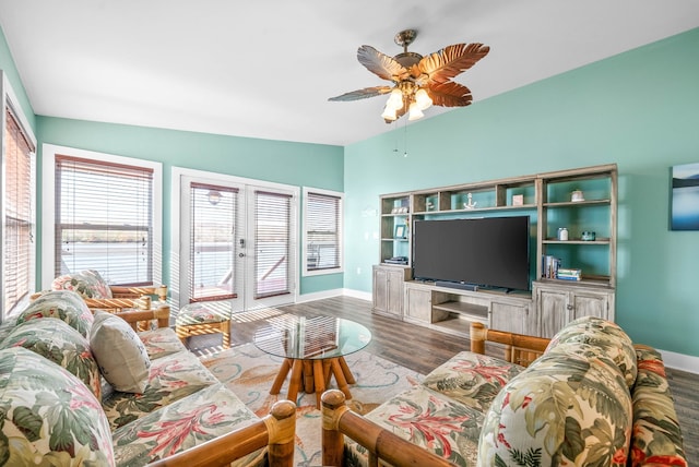 living room featuring hardwood / wood-style floors, ceiling fan, vaulted ceiling, and french doors