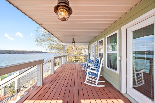 wooden deck with a porch and a water view