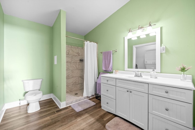 bathroom featuring a shower with curtain, hardwood / wood-style floors, vanity, and toilet