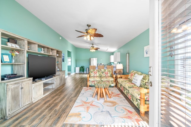 living room with ceiling fan, dark wood-type flooring, and lofted ceiling