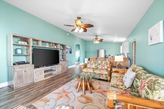 living room with ceiling fan, dark hardwood / wood-style flooring, and vaulted ceiling