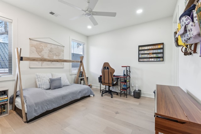 bedroom with light hardwood / wood-style flooring and ceiling fan