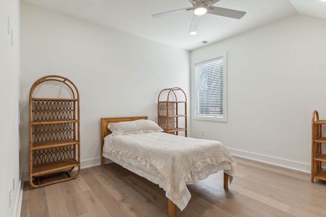 bedroom featuring hardwood / wood-style floors, ceiling fan, and lofted ceiling