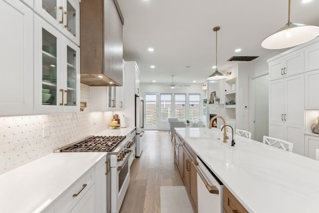 kitchen with white cabinets, white appliances, and decorative light fixtures