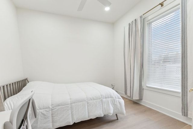 bedroom with ceiling fan and light wood-type flooring