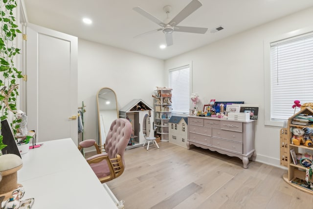 office with ceiling fan and light hardwood / wood-style floors