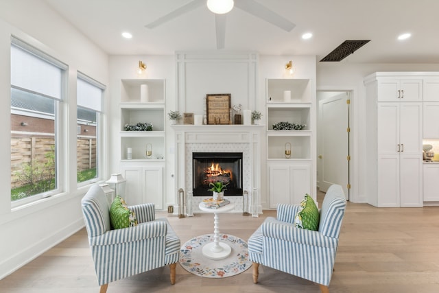 living area with light hardwood / wood-style flooring and ceiling fan