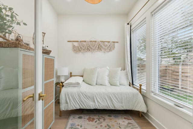 bedroom featuring multiple windows and hardwood / wood-style floors