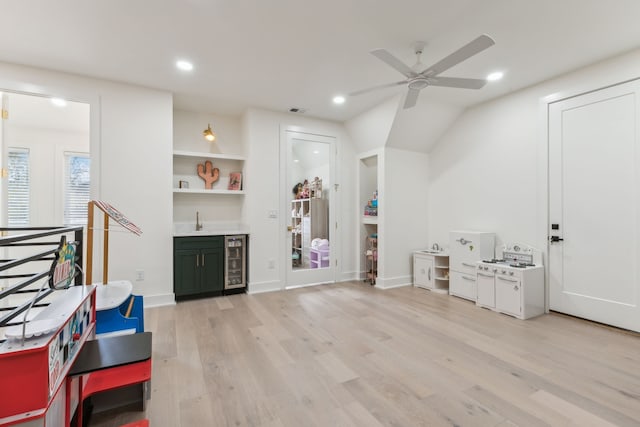 interior space featuring ceiling fan, light hardwood / wood-style floors, beverage cooler, and built in shelves