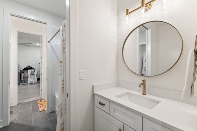 bathroom with ceiling fan, tile patterned flooring, vanity, and shower / bath combo