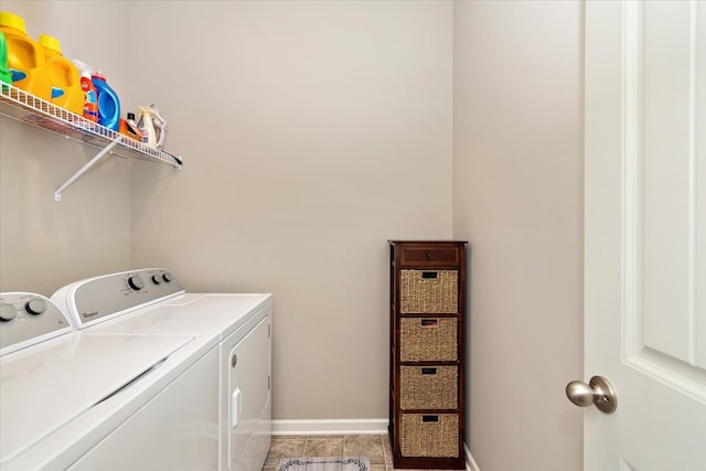 laundry area with washing machine and dryer and light tile patterned floors