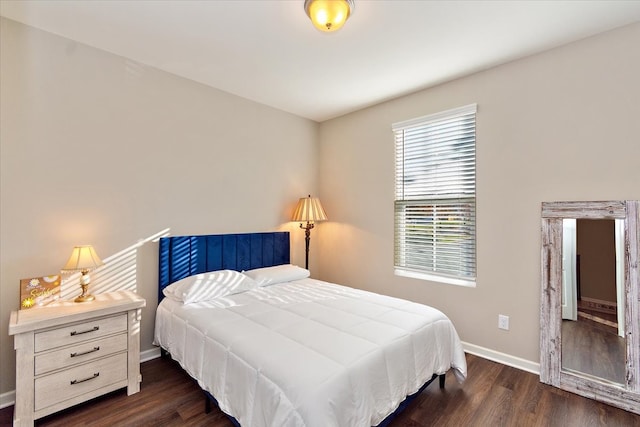 bedroom with dark hardwood / wood-style floors