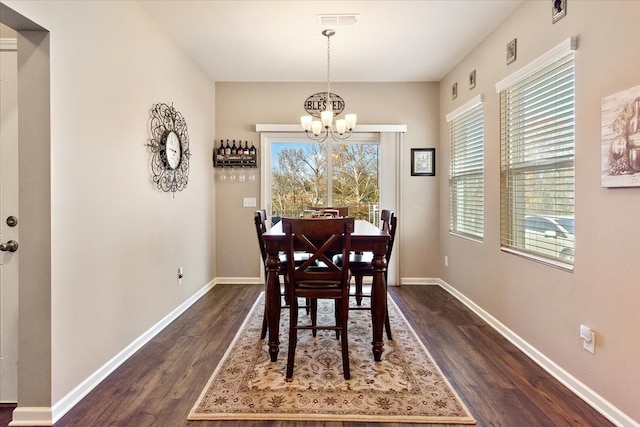 dining room featuring a chandelier and dark hardwood / wood-style flooring