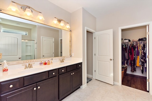 bathroom with tile patterned floors, vanity, and a shower with shower door