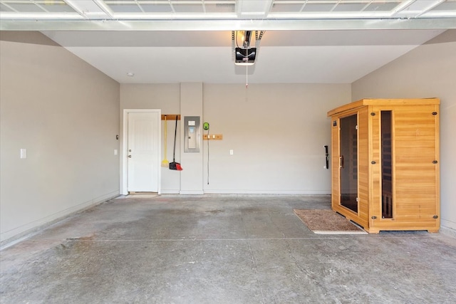 garage featuring electric panel and a garage door opener