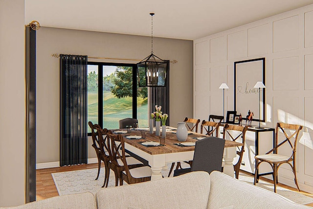 dining space with light hardwood / wood-style flooring and an inviting chandelier