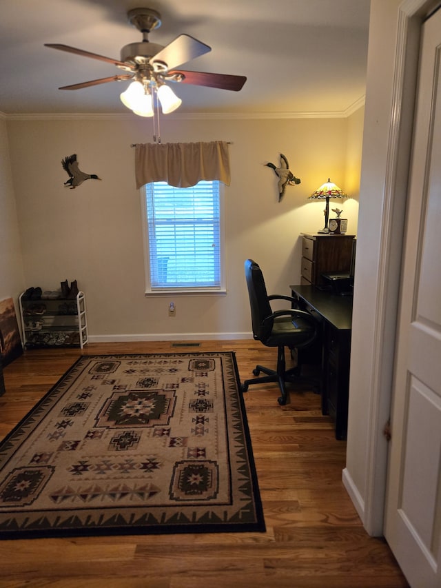 home office featuring ceiling fan, crown molding, and wood-type flooring